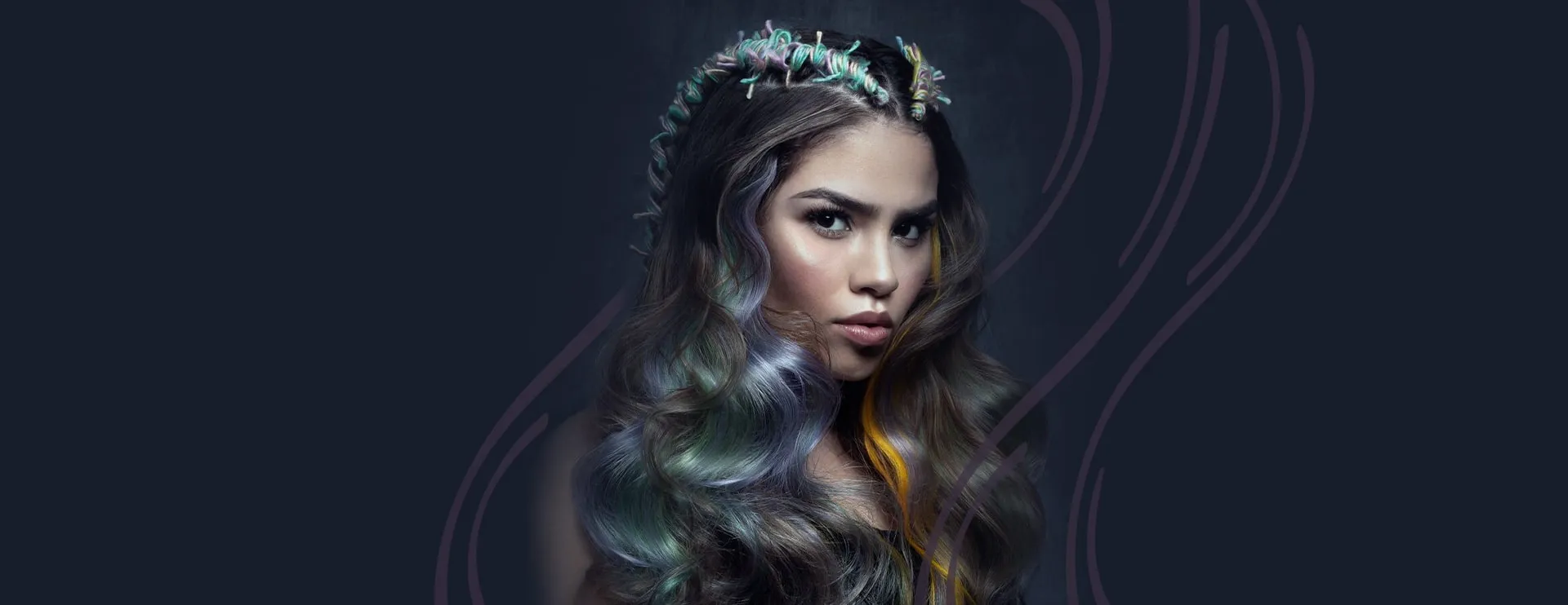 Editorial portrait of a student's pastel color work — braided crown and lavender-and-sage waves